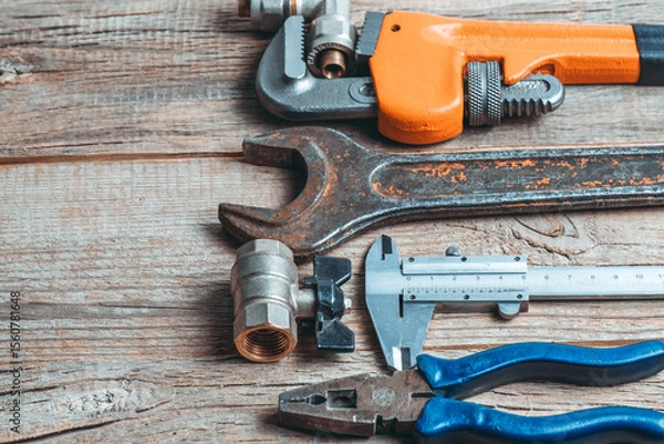 Obraz Variety of plumbing tools on wooden background. Copy space for text.