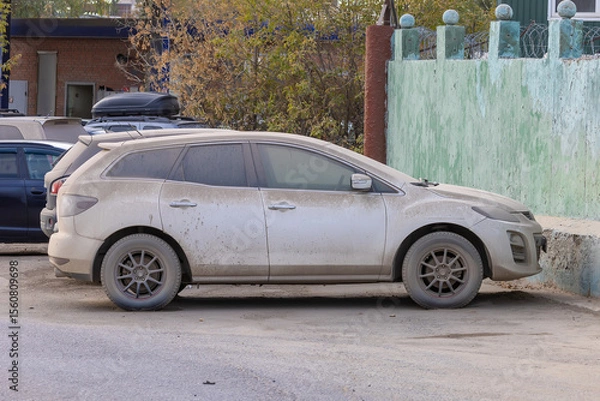Fototapeta Dust covered cars parked on a city street with faded paintwork, highlighting neglect and urban decay, two vehicles side by side in a dusty environment, weathered conditions