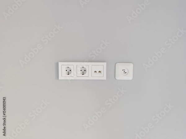 Obraz White electrical outlets on a soft gray wall creating minimalist vibe