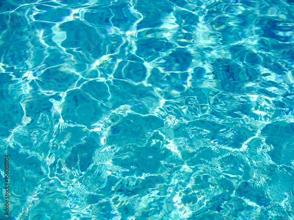 Fototapeta Sparkling blue water with flowing ripples under bright sunlight reflecting light