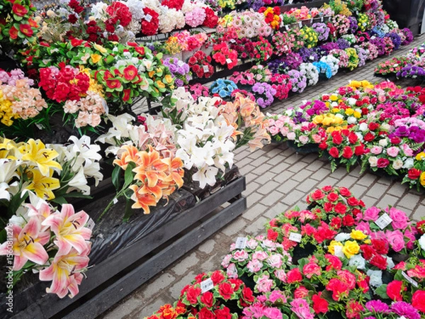 Fototapeta Vibrant array of artificial flowers in various colors and arrangements