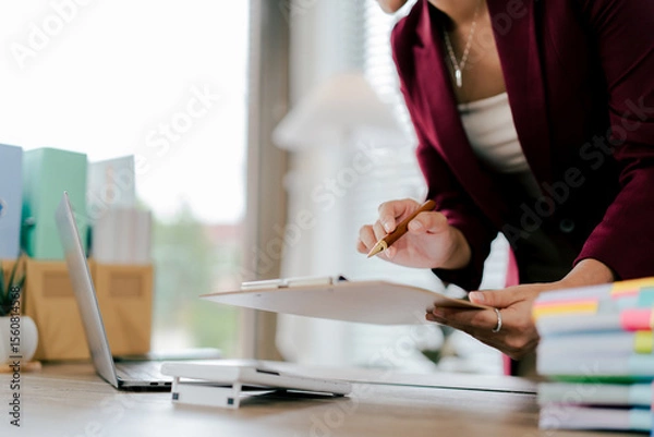 Fototapeta Asian business woman Business document check, account check, document search Legal documents, document preparation, reports, tax analysis, time, accounting, data sheets