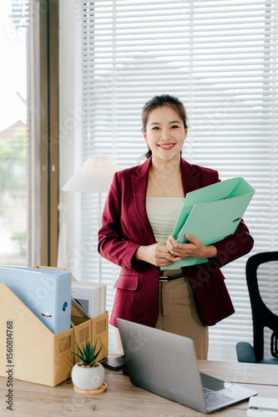 Fototapeta Female secretary holding file searching for documents in office. Young woman checking business documents, checking accounts, searching for documents, tax, accounting.