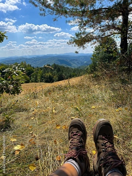 Obraz Resting Hiker with Boots Overlooking Mountain Landscape