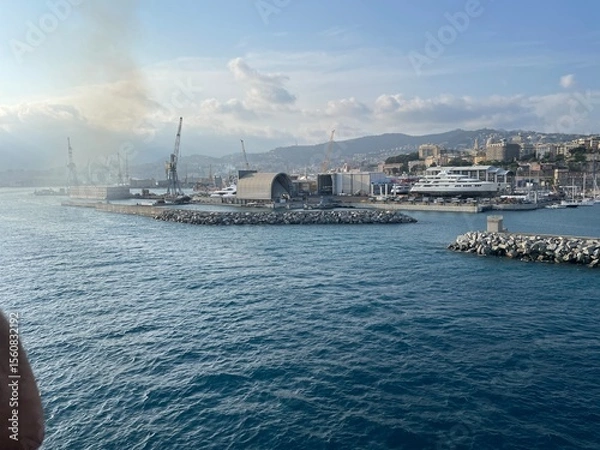 Obraz wide panoramic view of the harbor of Genoa. Blue sky blue sea white clouds and port buildings in harmony with the surrounding Mediterranean landscape