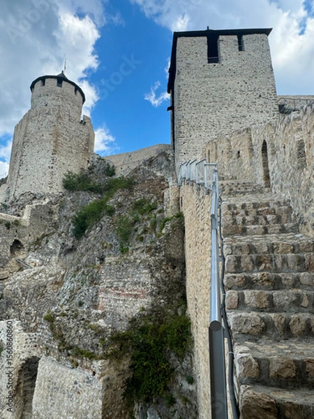 Obraz Golubac Fortress (Golubacka trvdjava, or Goluback Grad) taken during a sunny afternoon with windmills in background. The Golubac Castle was a medieval fortified town on the Danube River in Serbia