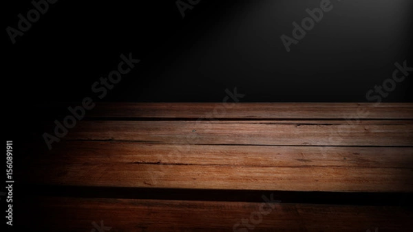 Obraz Light shines on empty wooden table with dark background. Top view of wooden surface for product placement with black backdrop.