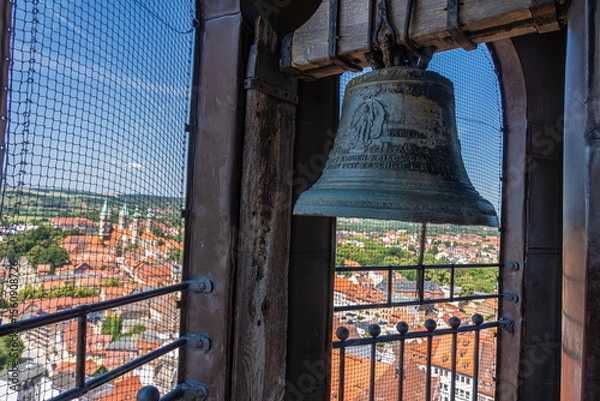 Obraz A large, detailed bell in a tower overlooking a picturesque cityscape