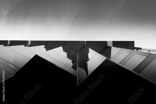 Obraz Modern architectural building with angular glass and sky
