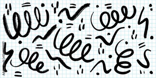 Fototapeta collection of abstract black brushstroke doodles and scribbles on a blue graph paper background.
