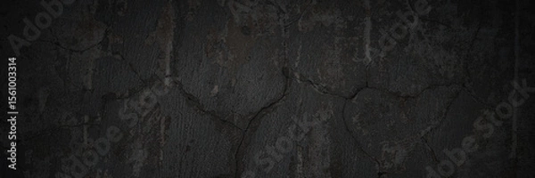 Fototapeta Texture of the old wall. Rough grungy surface of painted plastered concrete wall with spots, cracks, noise and grain. Dark wide panoramic background for design. Shaded vintage texture with vignette.