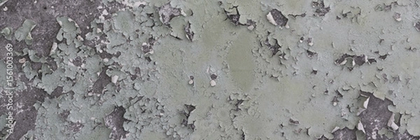 Fototapeta Peeling paint on the wall. Panorama of a concrete wall with old cracked flaking paint. Weathered rough painted surface with patterns of cracks and peeling. Wide panoramic grunge texture for background