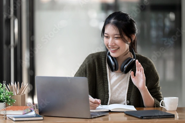 Obraz Hipster teen girl school student wear headphone watch video online webinar learn on laptop elearning course video conference pc call in library
