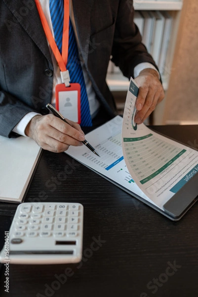 Obraz an accounting and financial officer is working on documents in the office, a businessman is reviewing his company's historical budget statistics, finance, marketing