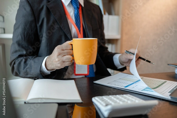 Obraz an accounting and financial officer is working on documents in the office, a businessman is reviewing his company's historical budget statistics, finance, marketing