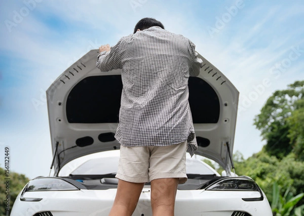 Fototapeta Traveler Fixing Electric Car with Possible Breakdown or Dead Battery