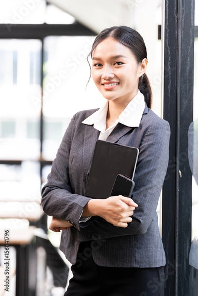 Obraz Portrait of happy businesswoman with touchpad in office, smiling to camera