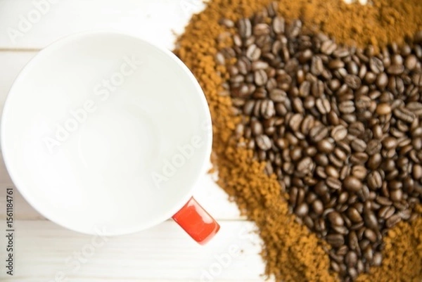 Fototapeta Flat design white ceramic mug with red handle is resting beside roasted bean heart, grounds