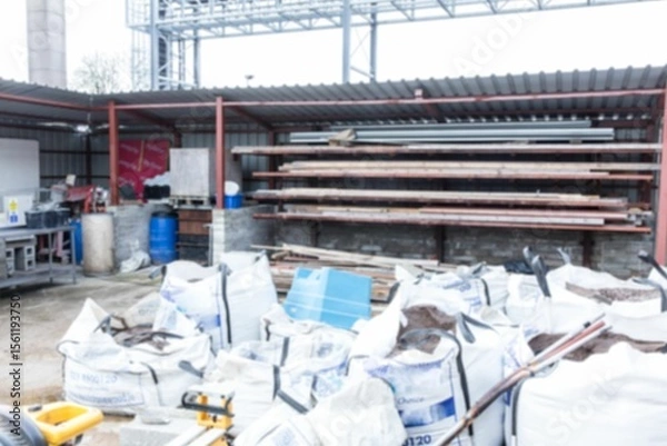 Obraz White bulk bags are being shown in flat design storage area, with pipes and pallet jack