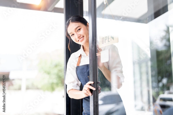 Obraz Small business owner at entrance looking at camera