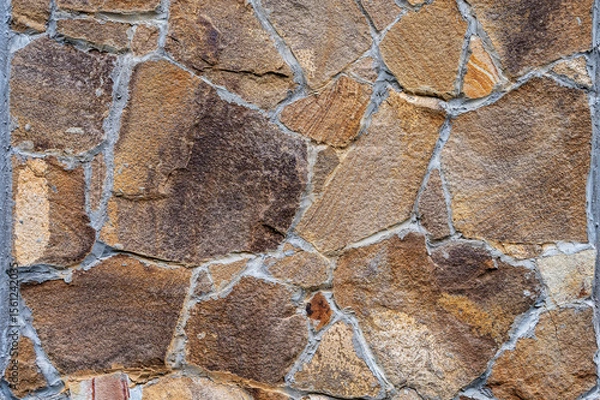 Fototapeta Texture of wall lined with natural stone. Template, background or wallpaper sample.
