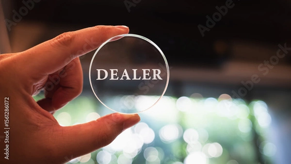Fototapeta The word dealer is laser-engraved into the glass plate, the concept of a dealer with trust and confidence with a leading company.