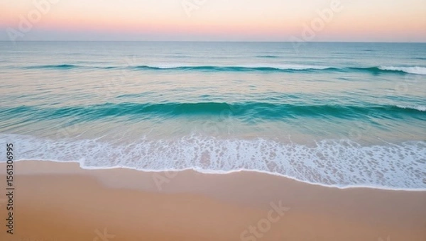 Obraz Wide aerial shot of a calm beach at golden hour, soft ocean waves gently brushing over smooth sand, light pink and orange hues in the sky. No people, minimal composition, ultra-high resolution, perfec