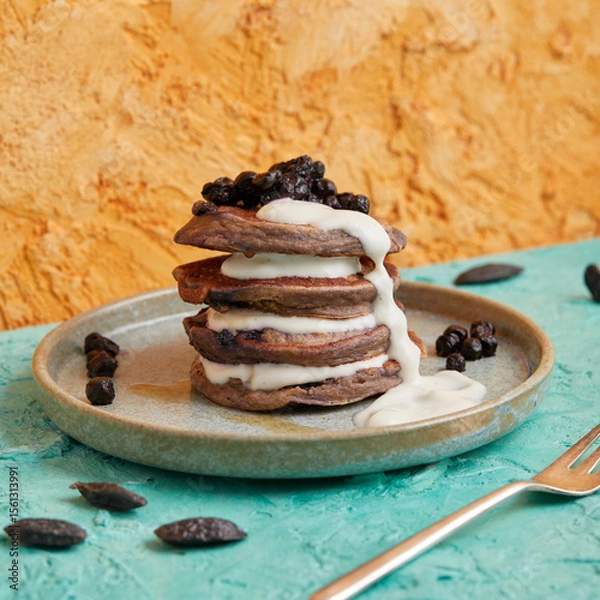 Fototapeta Mini pancake stack with blueberries and white cream topping