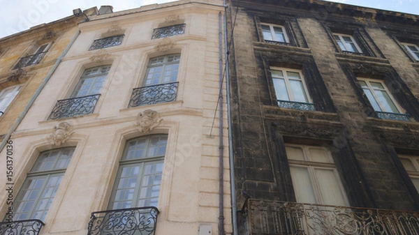 Fototapeta comparison of wall building street facade before and after cleaning with real difference between cleaned and dirty house 