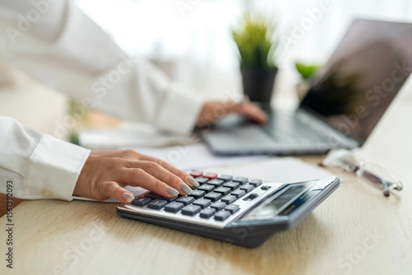 Fototapeta Human use calculator and calculate bills and paying bill, credit card, tax and vat, payment, concept of money management and business report with financial documents, financial accounting concept