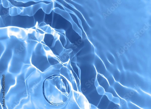 Obraz Abstract blurred shades of blue water background. Light and shadow ripples or splashes surface of water texture. Water waves and bubbles with shining and reflection pattern photography for​ artwork.
