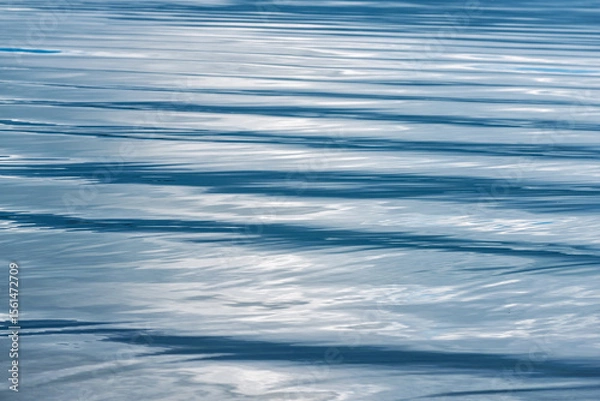 Obraz Rippling blue water surface reflecting light during midday at a tranquil lake