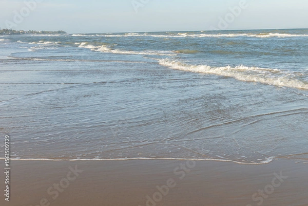 Obraz waves crash on the beach sand for background