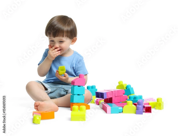 Fototapeta Cute little boy playing with building bricks on white background