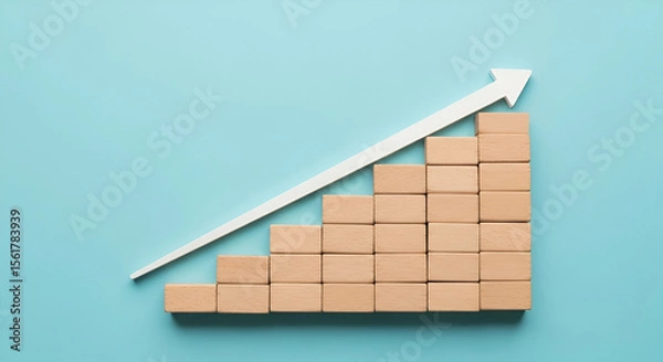 Fototapeta Wooden Blocks Forming a Growth Chart with White Arrow on a Blue Background Illustrating Business Success and Financial Progression