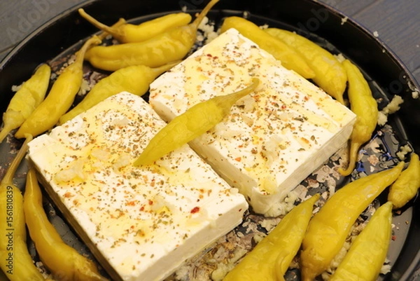 Fototapeta Baked feta cheese with pepperoni and onions	