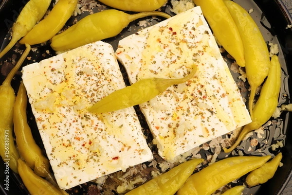 Fototapeta Baked feta cheese with pepperoni and onions	