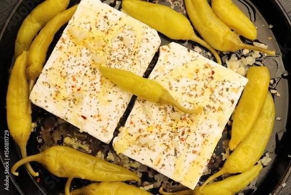 Fototapeta Baked feta cheese with pepperoni and onions	