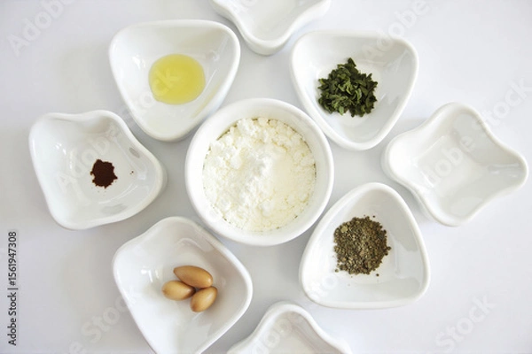 Fototapeta A group of white bowls filled with different types of food.