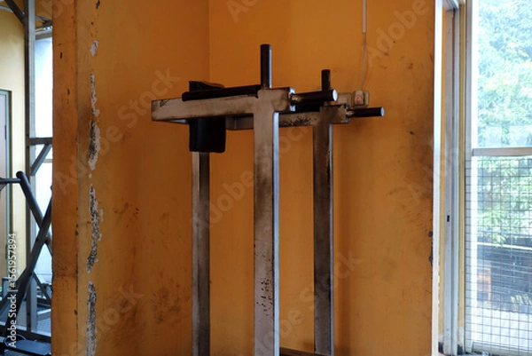 Fototapeta Worn Out Gym Dip Station Against Yellow Wall