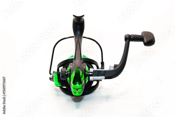 Obraz Green fishing reel with fishing line isolated on white background ideal for outdoor activities and sports. Photos from all angles sides.