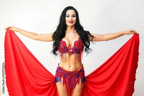 Obraz Elegant Eastern Dancer Gracefully Holding the Edges of Her Skirt Captivating Performance.