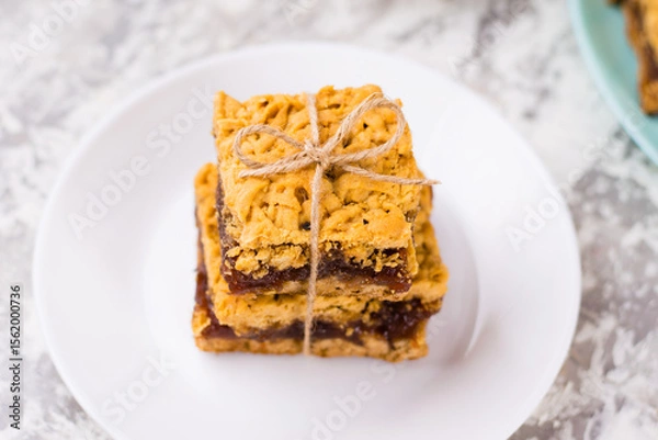 Obraz Delicious homemade pie with apple jam. Appetizing slices of grated pie with jam on a white plate on a light table