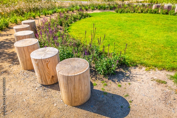 Obraz Cozy seating area in a park, garden or patio made from natural wooden logs