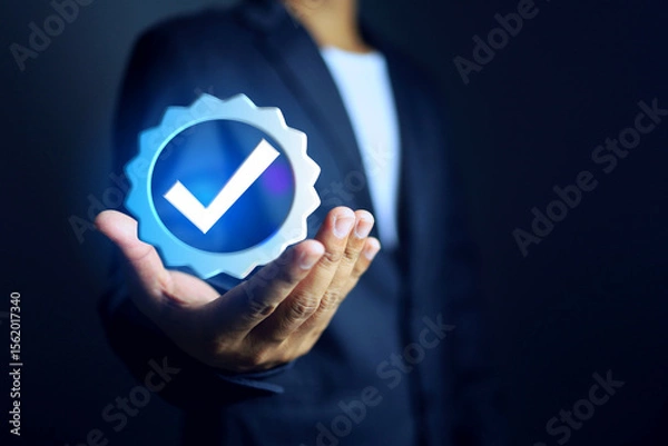 Fototapeta certificate concept with businessman holding a certified mark with check mark represent to get approved by standards and compliance of requirement