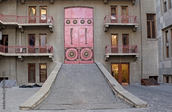 Obraz red wooden door with tile trim at the yerevan