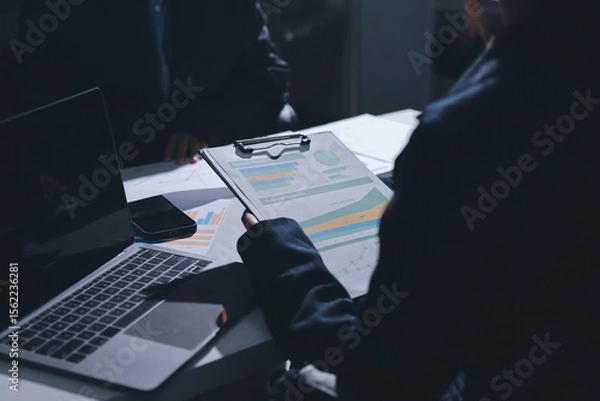 Obraz Group of business women working on a financial data expenses document.
