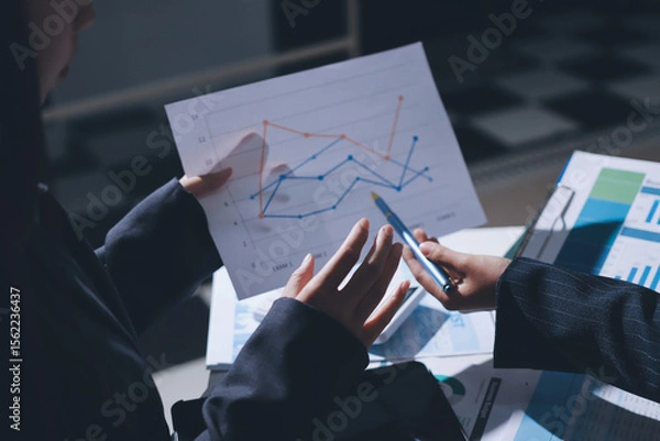 Obraz Group of business women working on a financial data expenses document.