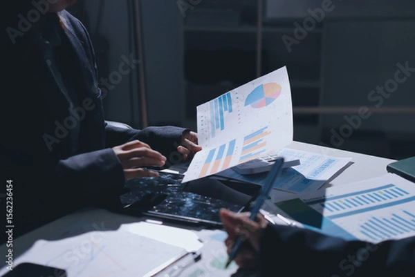 Obraz Group of business women working on a financial data expenses document.