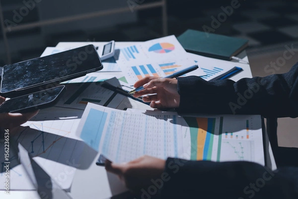 Obraz Group of business women working on a financial data expenses document.